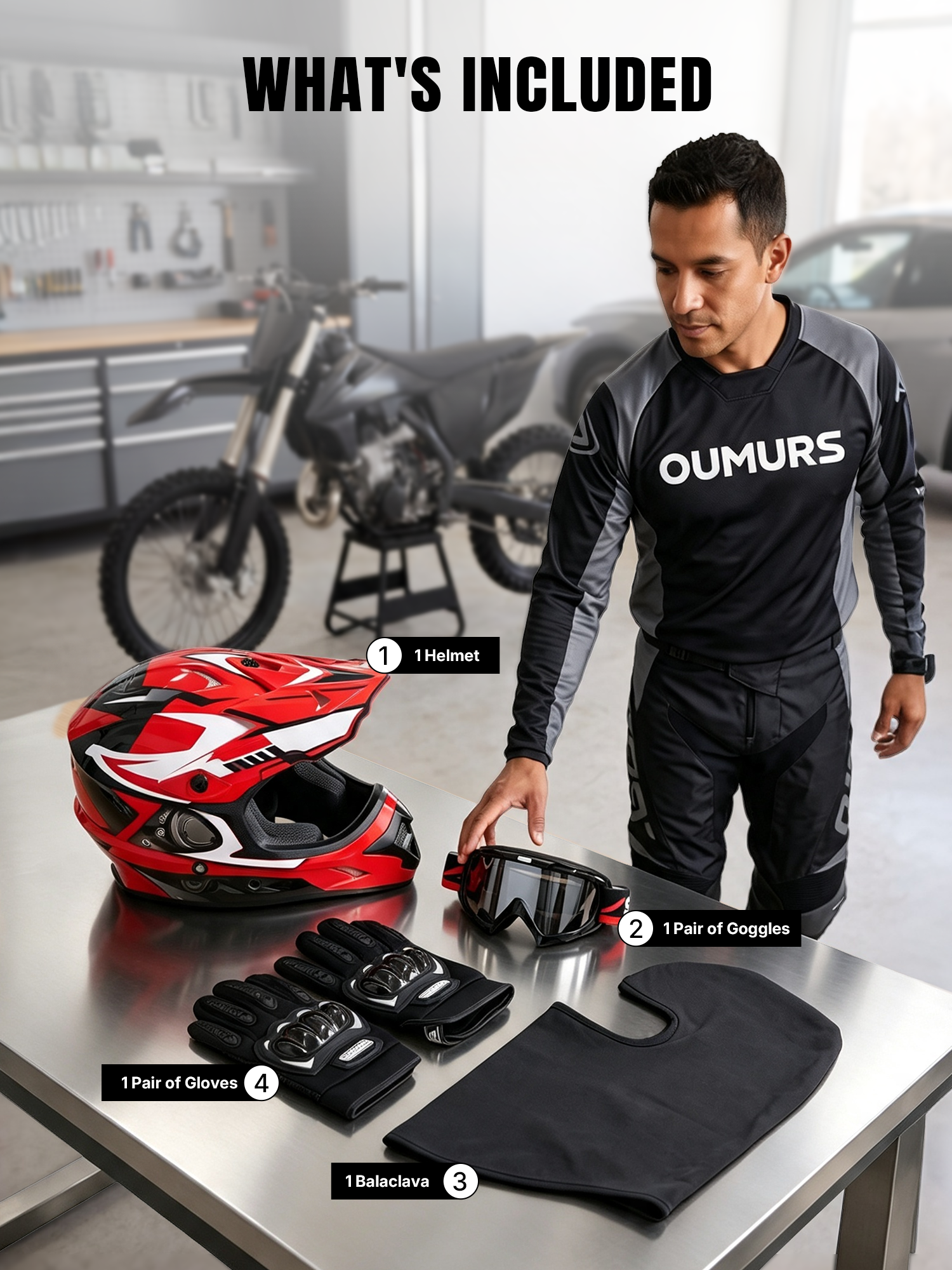 A man standing beside a table in a garage, displaying an Oumurs 805 Engine Red off-road motocross helmet, a pair of UV-protective goggles, a pair of gloves, and a balaclava.