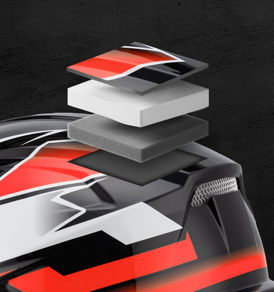 Close-up of a black, white, and red helmet shell with layered foam inserts and a textured vent detail, shown against a dark textured background.