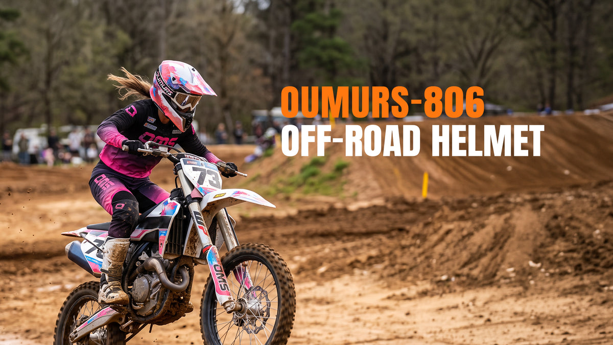 An off-road motorcycle rider wearing an Oumurs 806 PINK SPLASH motocross helmet maneuvers an orange and white dirt bike through dusty terrain in the mountainous desert.