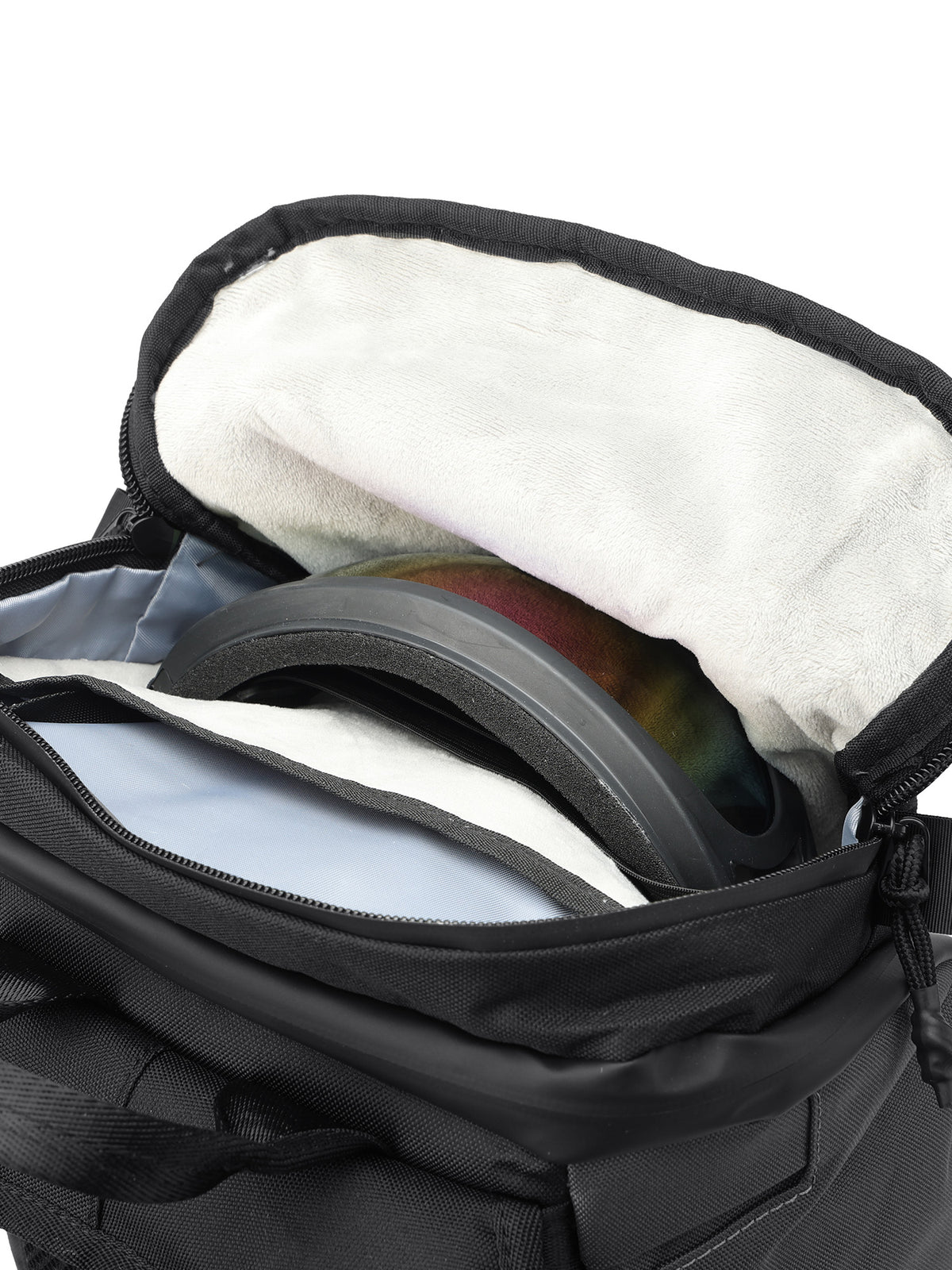 Close-up of motorcycle goggles stored in the backpack’s soft-lined zippered pocket.