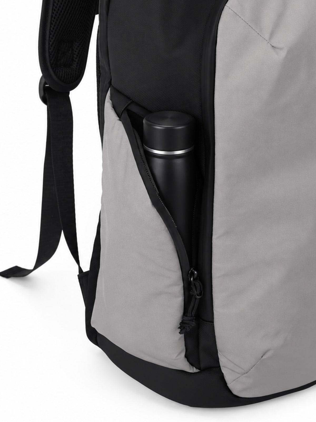 Close-up of a gray and black backpack showing a side pocket with a black insulated bottle inside, on a white background.