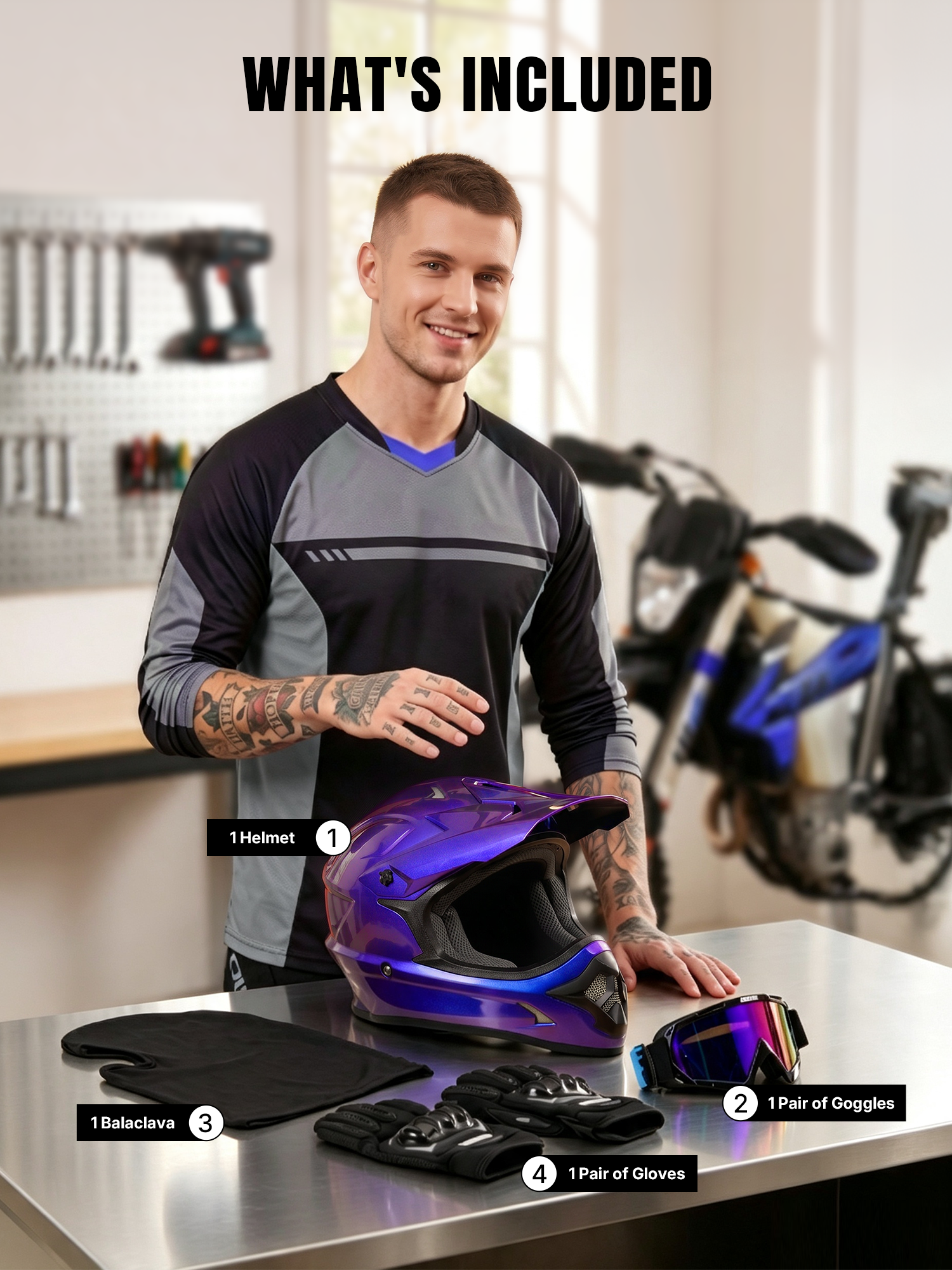 A man standing beside a table in a garage, displaying an Oumurs 805 Chameleon Purple off-road motocross helmet, a pair of UV-protective goggles, a pair of gloves, and a balaclava.