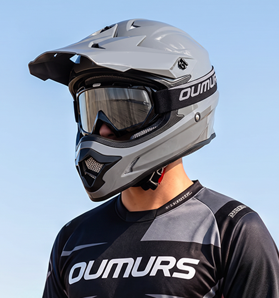 A rider wearing an Oumurs 805 Gray off-road helmet with UV-protective goggles.