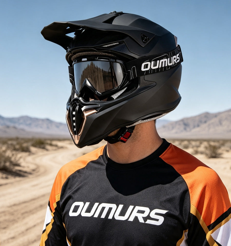 A rider wearing an Oumurs 806 Matte Black off-road helmet with UV-protective goggles.