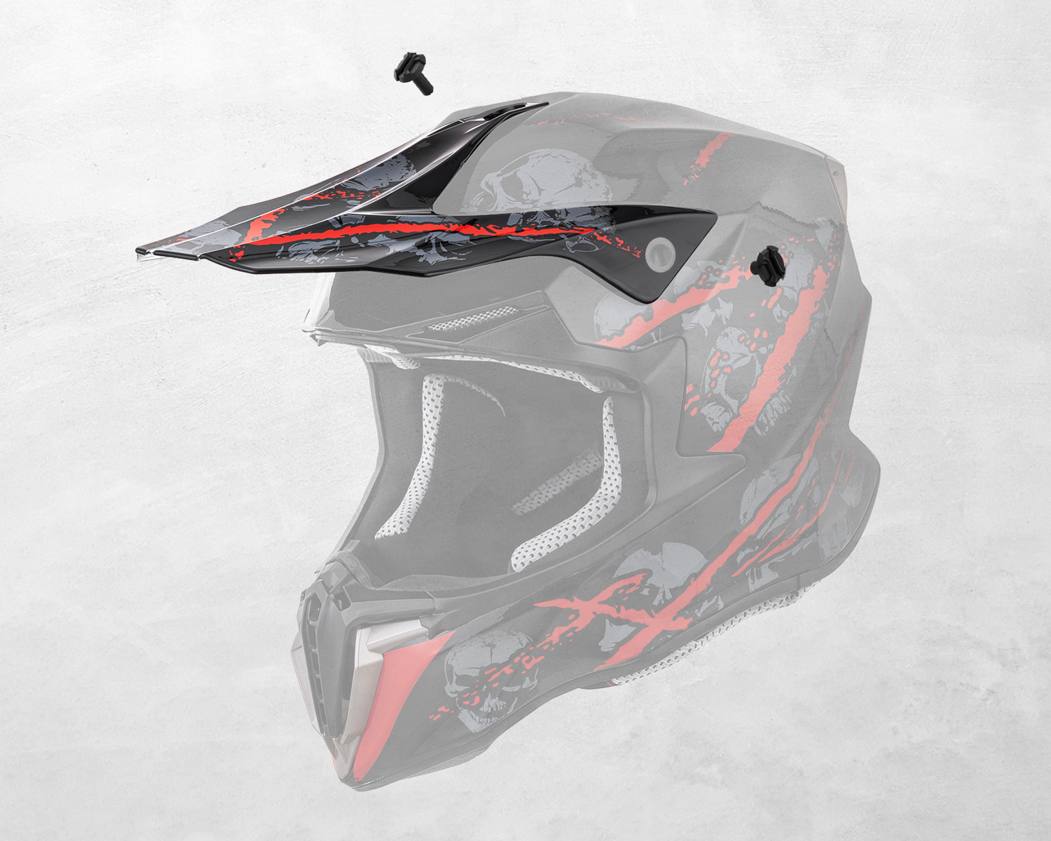 The Oumurs 806 Red Skull off-road helmet's peak shown detached with mounting screws.