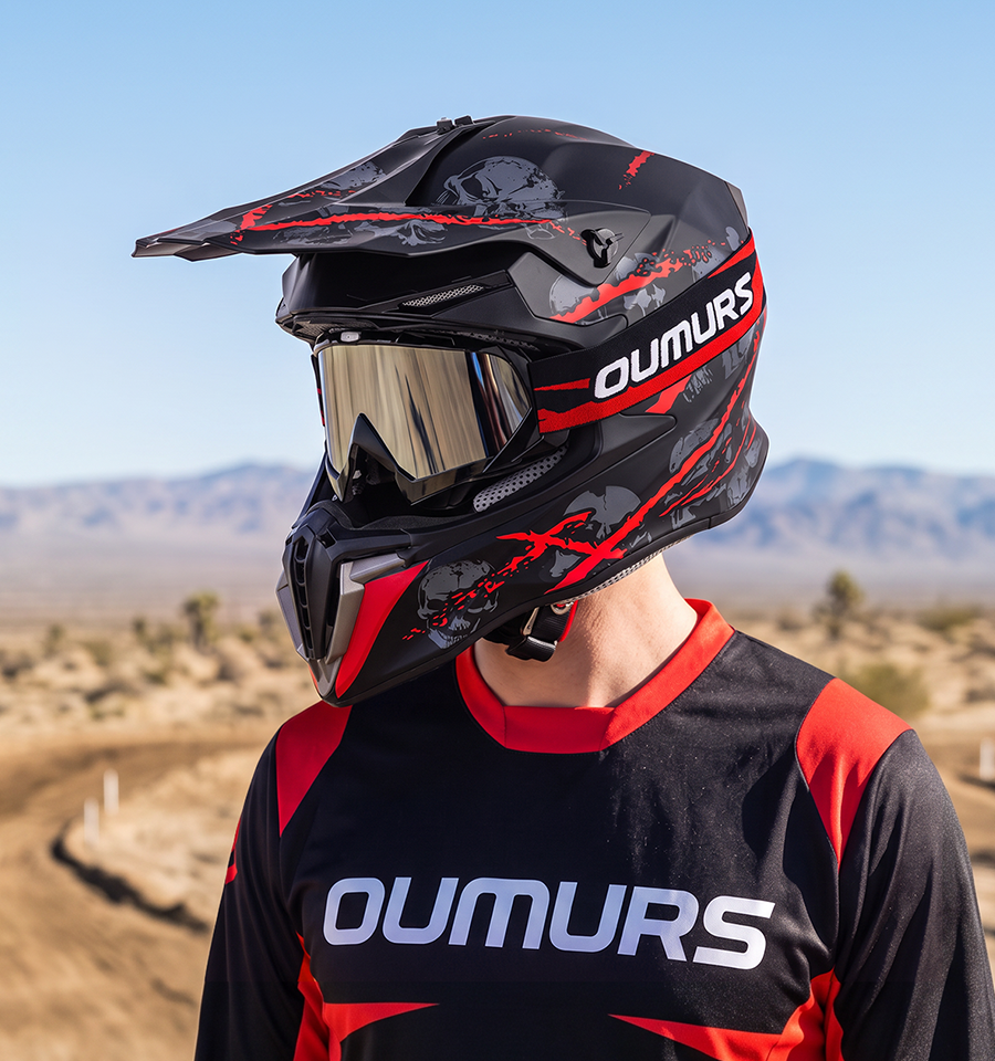 A rider wearing an Oumurs 806 Red Skull off-road helmet with UV-protective goggles.