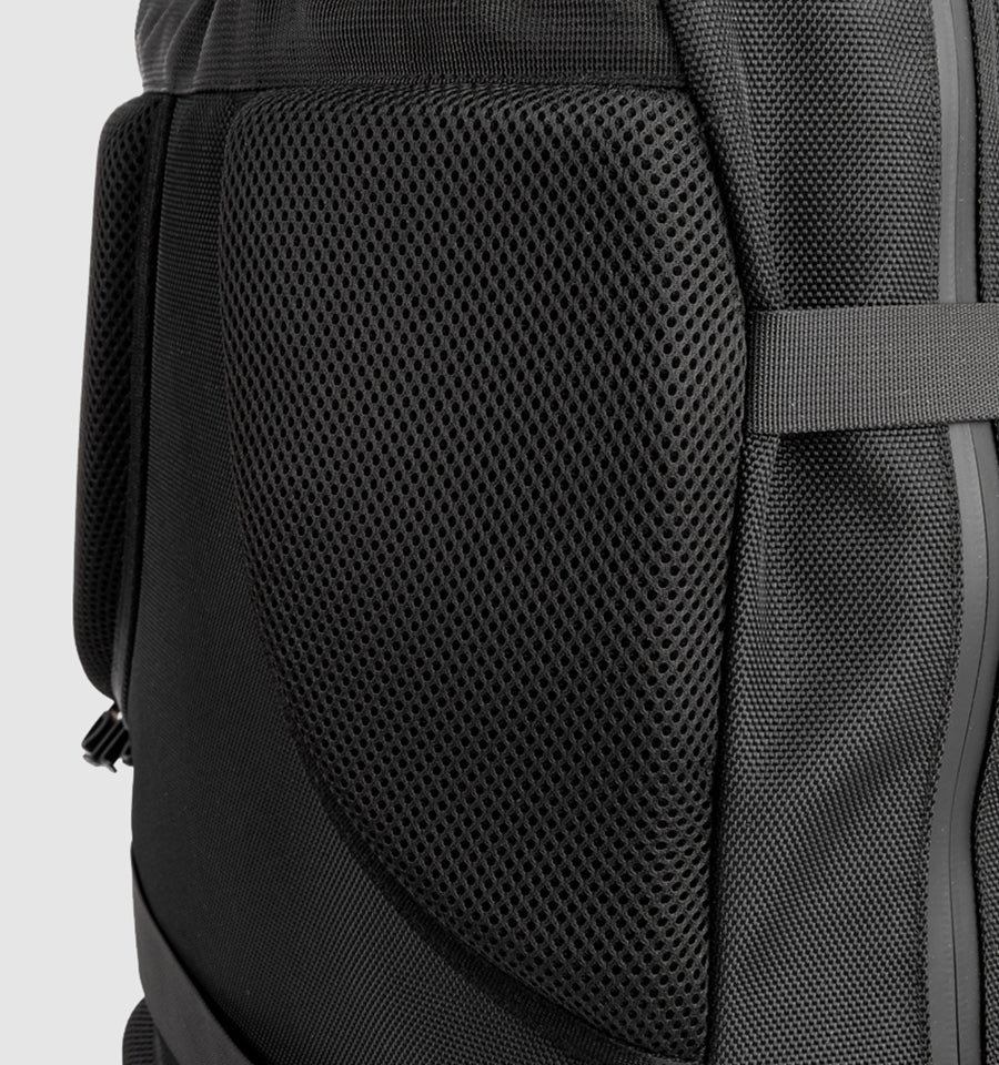 Close-up of the padded mesh back panel on a black motorcycle backpack