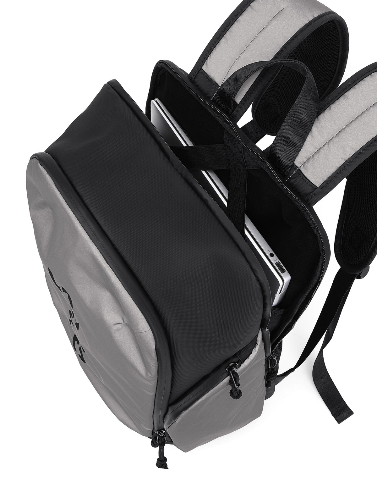 A black and gray backpack shown from an angled top-down view, with its main compartment open to reveal a silver laptop inside. The backpack features padded shoulder straps and a clean white background.