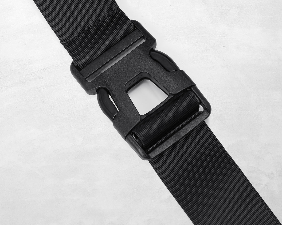 Close-up of the black side-release buckle and woven strap on an Oumurs motorcycle leg bag