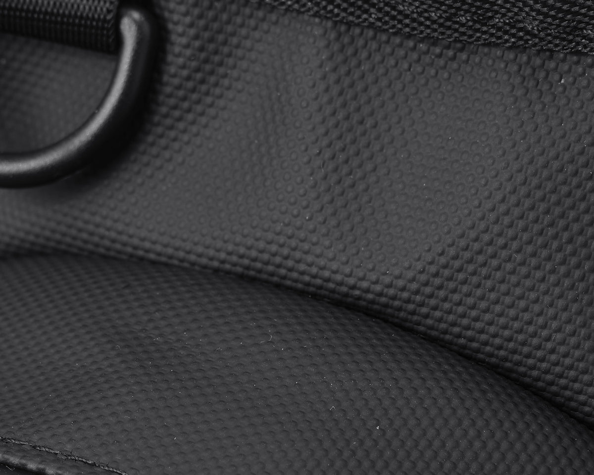 Close-up of the textured black fabric, stitching and D-ring on an Oumurs motorcycle leg bag.